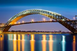 Il ponte di Bayonne illuminato al crepuscolo (Francia). E' uno dei ponti ad arco in acciaio più lunghi al mondo.
