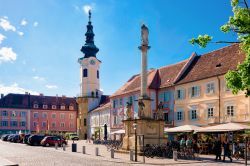 La piazza principale di Bad Radkersburg, Austria, con il Municipio, la colonna Plague e gente seduta nei caffé. Siamo in una delle più suggestive stazioni termali della Stiria ...