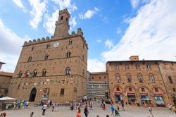La piazza principale di Volterra affollata di turisti, Toscana. Piazza dei Priori è il centro della città medievale: gli edifici che ne testimoniano il passato si affacciano proprio ...