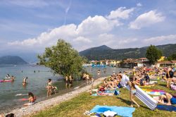 La spiaggetta di Iseo affollata di bagnanti in estate. Il Lago d'Iseo è il quarto lago per estensione della Lombardia - foto © katatonia82 / Shutterstock.com