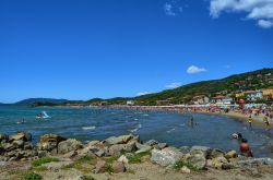 La spiaggia di sabbia di Castiglione della Pescaia, Toscana, con turisti in relax nei mesi estivi - © Massimo Parisi / Shutterstock.com