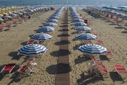 La spiaggia di sabbia di Viareggio nei pressi di Forte dei Marmi, Toscana, con ombrelloni e sdraio. Viareggio, altra località balneare della provincia di Lucca, si trova a poco più ...
