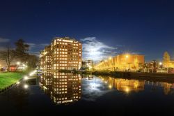 Moderno quartiere residenziale di Leiden, Olanda, by night: gli eleganti appartamenti illuminati si riflettono sull'acqua del canale.


