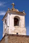 Particolare di un campanile nella città di Jerez de los Caballeros, Spagna. Sulla sommità si trova una statua di Gesù Cristo con le braccia aperte.

