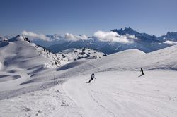 Sciatori sulle piste di Avoriaz nel comprensorio di Portes du Soleil, Francia. Sullo sfondo, le Alpi svizzere. 

