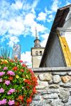 Scorcio dal basso di una chiesa con campanile a Les Contamines-Montjoie, Francia.
