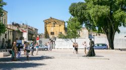 Turisti in posa vicino alla statua di Christian Montcouquiol (Nimeno II°, torero francese) in Place des Arenes a Nimes (Francia) - © vvoe / Shutterstock.com