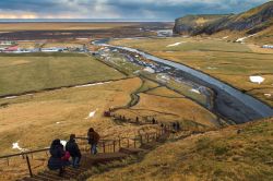 Turisti sulla scalinata che porta alla cima della cascata Skogafoss, Islanda. In soli 5 minuti (ma impegnativi) si può ammirare questa splendida meraviglia della natura dall'alto ...