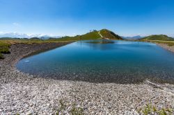 Un bacino di acqua nell'area alpina di Leogang, Austria, in una giornata di sole.

