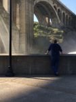 Un uomo guarda il paesaggio dal Maple Street Bridge a Spokane, Washington, Stati Uniti d'America. Inaugurato il 1° luglio 1958, questo ponte da 6 milioni di dollari si estende su Peaceful ...