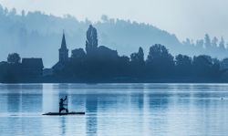 Un uomo pratica Sup (Stand up paddle) nei pressi del villaggio di Busskirch (Kirchdorf), a Rapperswil-Jona. Si tratta di una variante del surf in cui si sta in piedi su una tavola.
