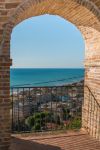 Una bella veduta del mare da un arco nel borgo di Grottammare, Ascoli Piceno.
