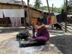 Una donna lava i panni in un villaggio di moken, gli "zingari del mare", arcipelago di Mergui (Myanmar) - © Apik / Shutterstock.com