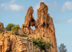 Una finestra naturale nella roccia granitica, con una curiosa forma di cuore: siamo tra i Calanchi di Piana, le famose formazioni rocciose erose della Corsica - © Jon Ingall / Shutterstock.com ...