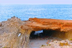 Una grotta tra le rocce rosse della costa di Terrasini, ad ovest di Palermo