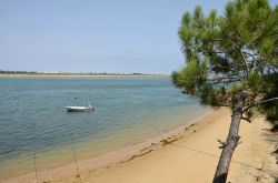 Una spiaggia sul fiume Guadiana a Vila Real de Santo Antonio, Portogallo. Una barchetta nelle acque azzurre del fiume.

