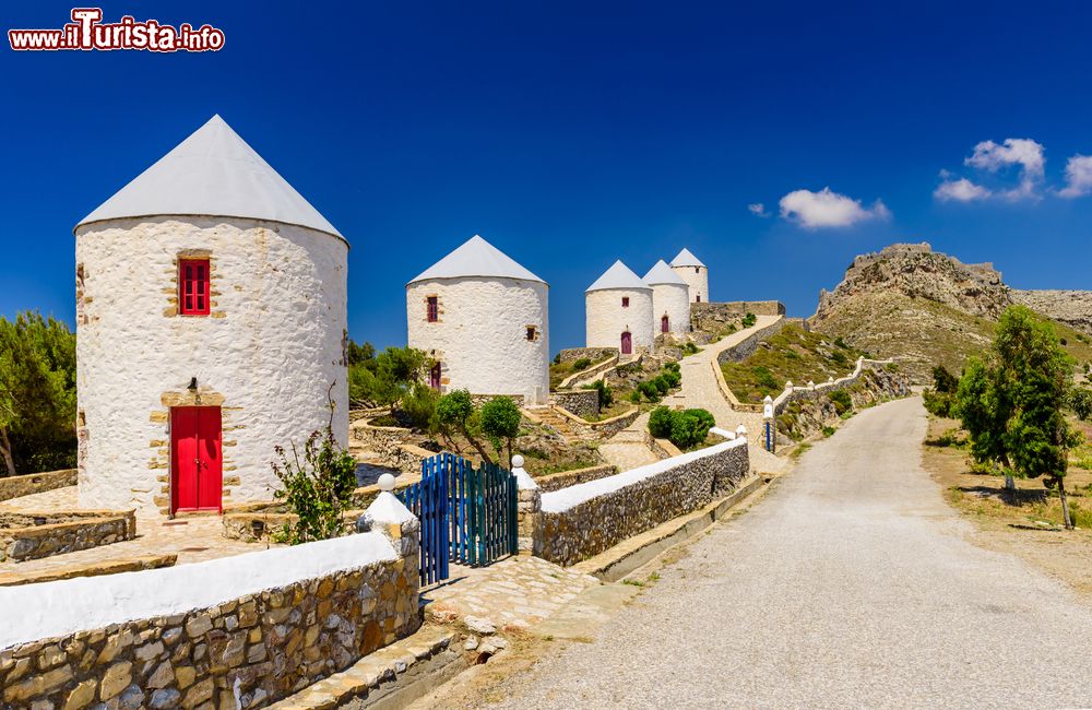 Immagine I pittoreschi mulini a vento del borgo di Agia Marina, isola di Lero, Grecia. Sullo sfondo, il castello della città del Dodecaneso.