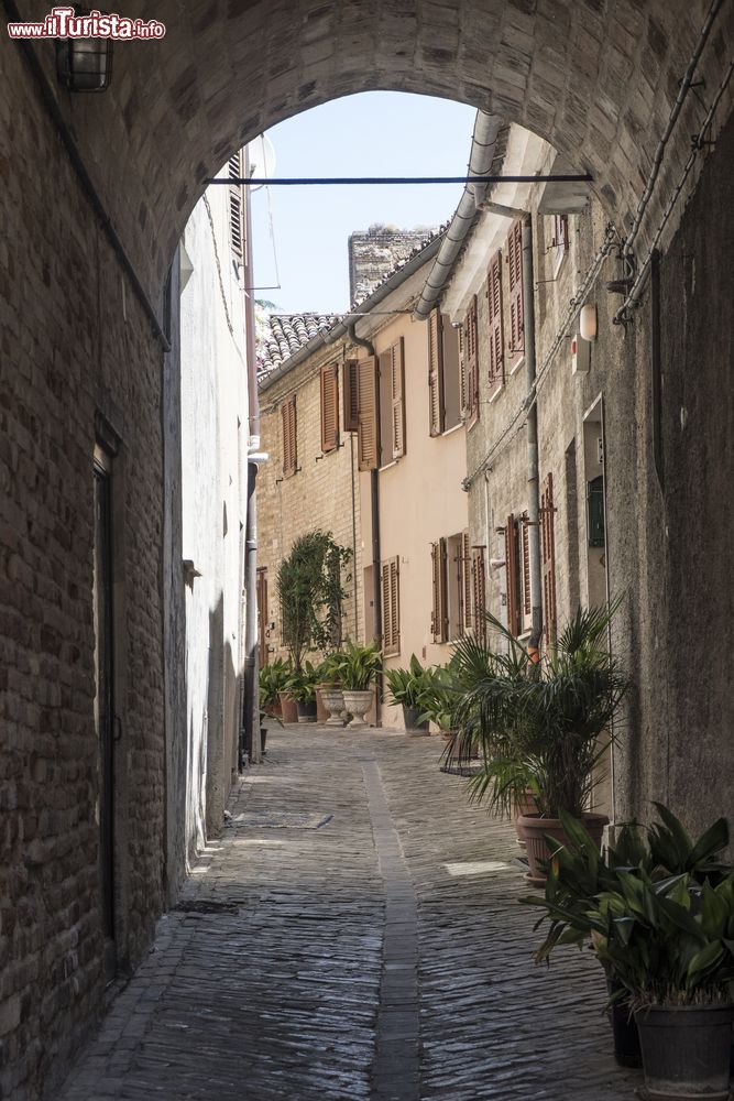 Immagine Scorcio panoramico del centro di Recanati, Marche, fotografato da sotto un porticato. Mattoni e ciottoli creano un'atmosfera d'altri tempi.