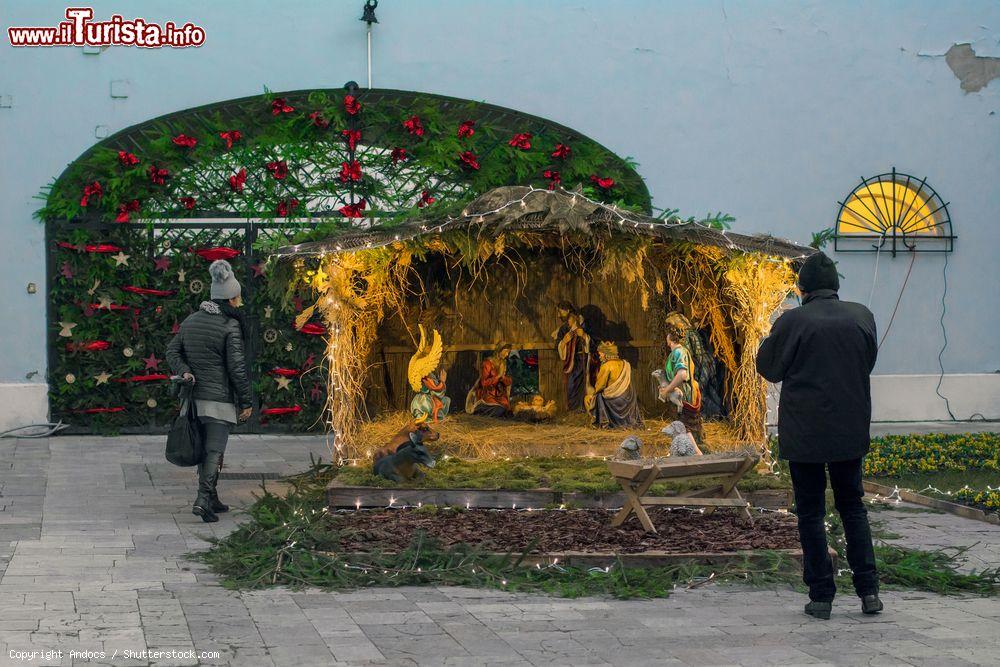 Immagine Gente in visita al tradizionale mercato natalizio nella piazza principale di  Szekesfehervar, Ungheria. In questa immagine, la rappresentazione della natività fotografata all'imbrunire  - © Andocs / Shutterstock.com