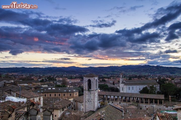 Immagine Tramonto e panorama di Gubbio . Per quanto riguarda il clima non esiste un periodo migliore per visitare Gubbio, per meglio dire ogni stagione ha il suo fascino e i suoi vantaggi per ammirare questa città dimenticata dal tempo. Se l’inverno è caratterizzato da temperature rigide e nebbie nei fondovalle, Gubbio diventa straordinaria per la luce radente, e durante il natale l’illuminazione della città e del monte Ingino ricoperto da luci a forma di albero gigante, valgono da sole il viaggio. A Gubbio può nevicare, e le temperature raggiungere valori anche molto negativi, ma con il sole la buona esposizione a sud-ovest del centro consente una visita gradevole, e dopo tutto la stagione invernale non è più piovosa delle altre. In primavera le giornate sono rese stupende dai giochi di colore del cielo e delle fioriture dell’Appennino. Le temperature crescono, si assiste a qualche episodio di variabilità ma il trend è quello che porta alle condizioni stabili estive, dove domina il sole ed il bel tempo con massime diurne prossime ai 30 °C. Se la calura diventa eccessiva basta qualche temporale che dai rilievi circostanti rovescia verso la città aria fresca rigenerante.- © Buffy1982 / Shutterstock.com