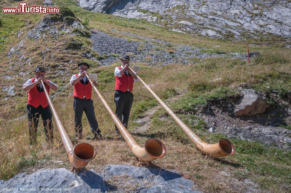 Immagine Tre suonatori di corno intrattengono gli ospiti di un lodge nel villaggio di Ovronnaz, Svizzera - © MoLarjung / Shutterstock.com