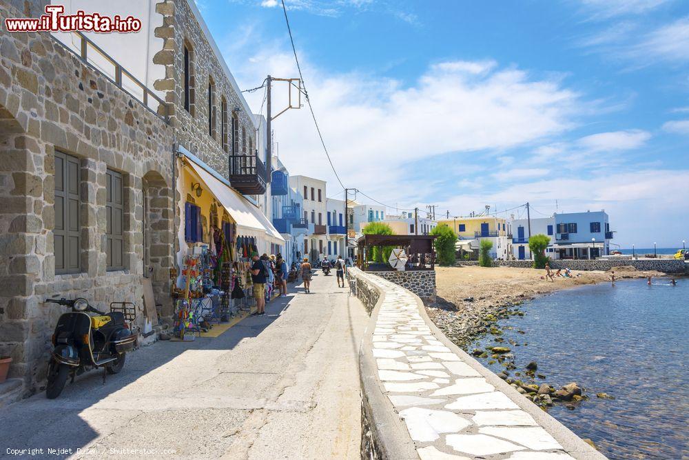 Immagine Turisti in una stradina del villaggio di Mandraki, isola di Nisyros, Grecia. Questo villaggio è poco più che una manciata di case bianche raggruppate attorno al castello dei Cavalieri dell'Ordine di San Giovanni costruito nel XV° secolo sul promontorio che delimita l'insenatura di Mandraki - © Nejdet Duzen / Shutterstock.com