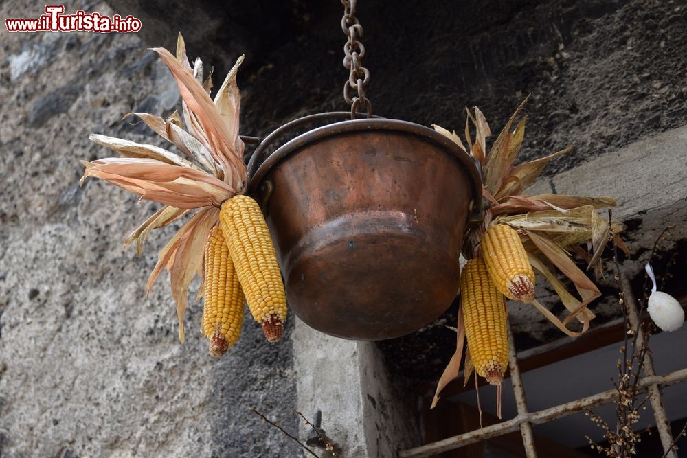 Immagine Un paiolo in rame con pannocchie nel borgo di Rango, Trentino Alto Adige.