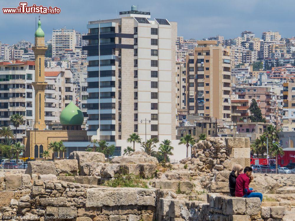 Immagine Una coppia araba seduta sulle rovine del castello di Sidone, Libano. Sullo sfondo, la moderna città situata 40 chilometri a sud della capitale Beirut - © Diego Fiore / Shutterstock.com
