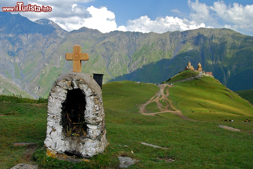 Immagine Una piccola cappella votiva a Gergeti, Georgia. Sullo sfondo Cminda Sameba, la chiesa ortodossa situata a 2170 metri di altitudine sotto il monte Kazbek.