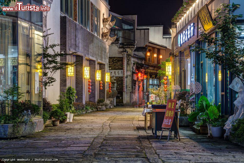 Immagine Una pittoresca stradina nel centro storico di Tunxi City by night, Huangshan (Cina) - © amadeustx / Shutterstock.com