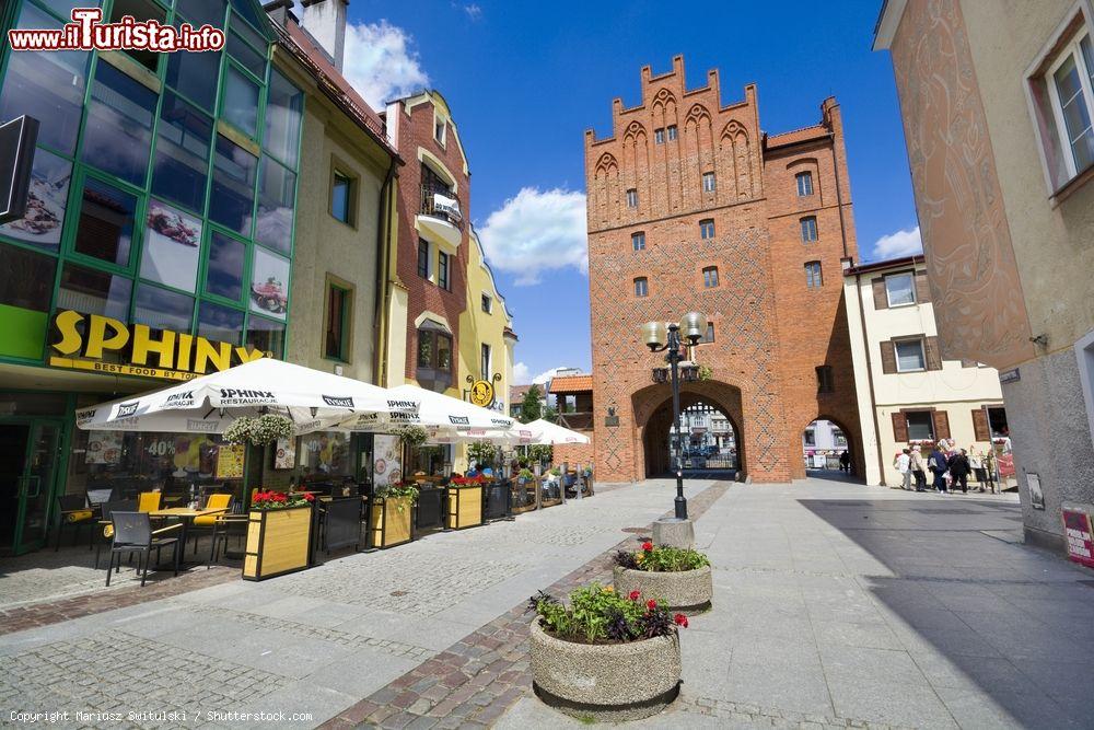 Immagine Una tipica stradina di ciottoli nel centro storico di Olsztyn, Polonia. La via si conclude con una porta d'ingesso e di uscita realizzata in stile gotico - © Mariusz Switulski / Shutterstock.com