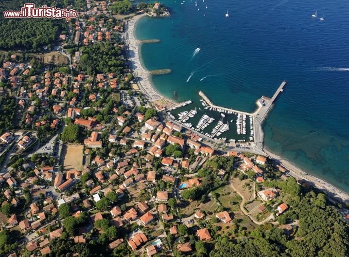 Immagine Veduta aerea della spiaggia di Cavo, Isola d Elba. Si estende per circa 420 metri e dal pontile arriva sino al promontorio roccioso sormontato da Villa Tonietti. Il lungomare è abbellito da palme e sculture.