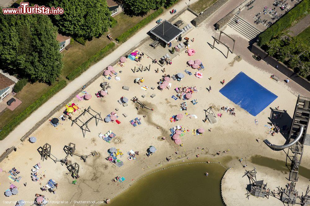 Immagine Veduta aerea di turisti in relax sulla spiaggia del lago a Hof van Saksen, provincia di Drenthe, Paesi Bassi. Questo territorio si trova nel nord-est della nazione - © Aerovista Luchtfotografie / Shutterstock.com