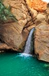 Cascata d'acqua e pozza limpida presso l'oasi di Chebika: ci troviamo sulle montagne,nella regione di Tozeur in Tunisia, al confine con il deserto del Sahara - © Igor Grochev / ...