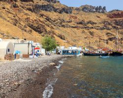 Una delle spiaggette di Thirasia (isole Cicladi, Grecia) accanto al porticciolo di Korfos. Il viavai dei pescatori anima da mattina a sera la cala di ciottoli, lambita da un'acqua limpidissima ...