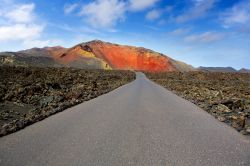 Strada dentro al Parco Nazionale di Timanfaya, a Lanzarote. Si tratta di uno dei parchi più affascinanti delle Canarie, caratterizzato da paesaggi vulcanici dall'aspetto lunare. Anche ...