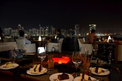 La vita notturna ad Abu Dhabi si svolge soprattutto nei locali e nei ristoranti più famosi; in questa foto siamo a cena su Al Maryah Island, nella terrazza del Rosewood Hotel, davanti ...
