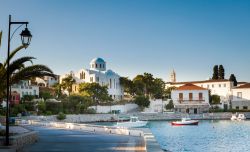 Passeggiata lungomare nella città di Spetses, Grecia. Sullo sfondo, l'antico monastero di Agios Nikolaos, cattedrale dell'isola.

