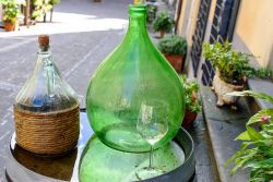 Un bottiglione e una piccola damigiana a Scansano ci ricordano che siamo nella città del Morellino in Toscana.