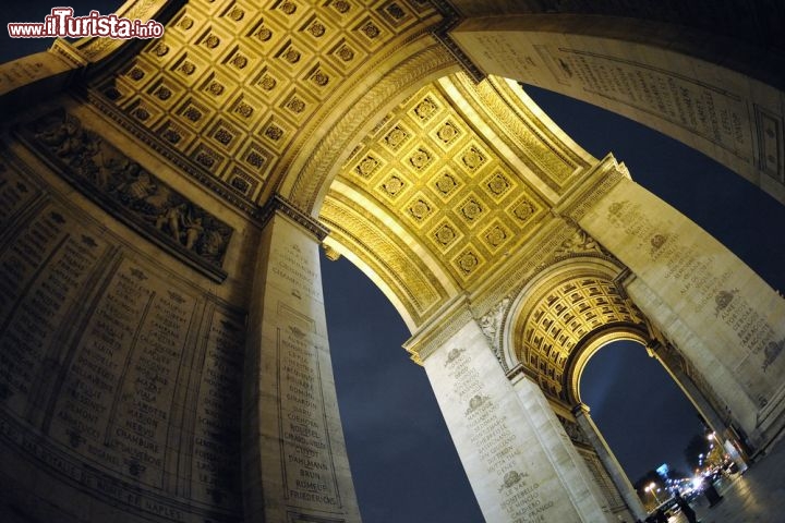 Immagine Fotografia notturna dell'Arco di Trionfo, Parigi - Suggestivo di giorno quanto al calare del sole, l'Arco di Trionfo offre un panorama unico sugli Champs Elysées considerati il più bel viale del mondo. Simbolo di Parigi, in questa immagine è ritratto dall'interno dove si possono leggere i nomi illustri della nazione © Taras Pozdnyakov / Shutterstock.com