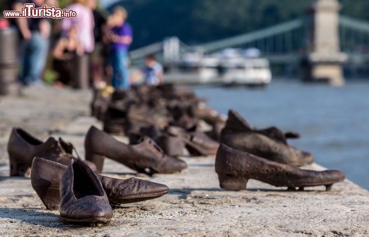 Immagine I turisti visitano il monumento all'olocausto a Budapest. Lungo il fiumeDanubio sono state installate 60 scarpe in metallo, che ricordano le vittime ebree che furono passate sulle armi dalle milizie delle Croci Frecciate ungheresi - © S-F / Shutterstock.com