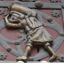 Un portatore de la Ribeira coloro che aiutarono la costruzione della Basilca celebrati sulle porte della chiesa di Santa Maria del Mar