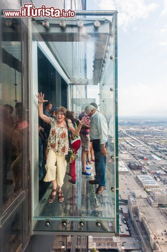 Immagine Alcuni turisti provano The Ledge uno dei tre baconi in vetro della Willis Tower, con panorama vertiginoso sulla città - © Julien Hautcoeur / Shutterstock.com