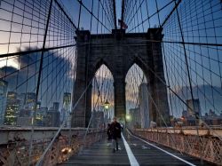 Camminando sul ponte di Brooklyn al tramonto