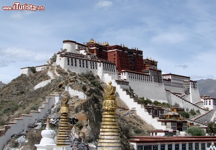 Palazzo del Potala, Lhasa, Tibet - Anche il Palazzo del Potala, situato nella capitale tibetana Lhasa, è un bene protetto dall’UNESCO. Il merito è certamente della sua storia centenaria cominciata nel 1600, della posizione panoramica mozzafiato e delle dimensioni colossali. L’edificio è largo 400 metri sul lato est-ovest e 350 metri sul lato nord-sud, costituito da enormi pietroni inclinati e rinforzato alla base con elementi di rame per fronteggiare i terremoti. Abbarbicato a 3700 metri di quota sulla Collina Rossa (Marpo Ri), il palazzo è alto 117 metri a partire dalla cima del colle, ma ben 300 metri dalla valle sottostante, e nei suoi 13 piani sono incasellate più di mille stanze, decorate da centinaia di migliaia di sculture. Oggi è un interessante museo, ma a lungo fu la dimora dei Dalai Lama. 