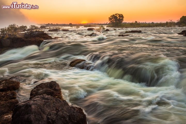 Livingstone raggiunse le cascate Vittoria provenendo da nord, lungo il percorso dello Zambesi. Il grande salto delle Victoria Falls era anticipato da delle rapide spettacolari, che ammiriamo in questa foto, e che rendevano particolarmente difficile la navigazione. Raggiunta l'odierna Livingstone Island, l'esploratore vide lo straordinario spettacolo delle cascate più belle del mondo, al pari forse di quelle brasiliane di Iguacu - © e2dan / Shutterstock.com