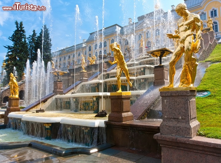 La fontana Grand Cascade, a Peterhof in Russia:  a pochi chilometri da San Pietroburgo, affacciata sul mare del Golfo di Finlandia, troviamo la spettacolare Reggia di Peterhof, Patrimonio UNESCO, complesso architettonico tra i più belli del mondo, voluto dallo stesso Zar Pietro il Grande. E' anche chiamata la Versailles della Russia. Una delle sue attrazioni principali è sicuramente la Grande Cascata, un complesso idraulico costituito da più di 60 fontane, caratterizzato da spettacolari giochi d'acqua, tutti ottenuti senza l'utilizzo di pompe idrauliche, ma semplicemente sfruttando la prevalenza fornita dalla posizione rialzata del serbatoio delle acque. La fontana venne ispirata, dal punto di vista tecnico, da quella francese del Château de Marly, ed è un capolavoro unico che fornisce un tocco elegante a tutto il lato nord del grande palazzo. Da qui le acque dalla reggia scendono direttamente fino al Golfo di Finlandia. Da segnalare, tra le 225 sculture in bronzo che la ornano, la grande statua di Sansone, un riferimento alla vittoriosa guerra vinta dalla Russia di Pietro I contro la Svezia, quest'ultima rappresentata dal leone, a cui Sansone apre a forza le fauci, consentendo l'uscita di un getto d'acqua alto 20 metri - © Sailorr / Shutterstock.com