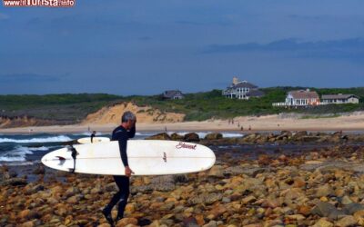 un_uomo_con_il_surf_sulla_spiaggia_di_ditch_plains_a_montauk